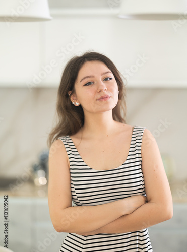 Young smiling woman posing standing in kitchen at home Free Download Young smiling woman posing standing in kitchen at home - GFXLoad