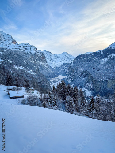 Obraz na płótnie Panoramic view of Lauterbrunnen Valley, Switzerland seen from Wengen with snowcovered Breithorn mountain in winter against blue sky with clouds w salonie