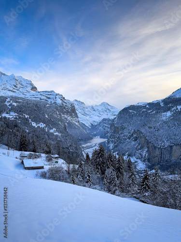 Obraz na płótnie Scenic view of Lauterbrunnen Valley, Switzerland seen from Wengen with snowcovered Breithorn mountain in winter against blue sky with clouds w salonie