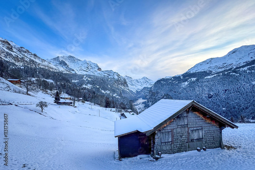 Obraz na płótnie Panoramic view of Lauterbrunnen Valley, Switzerland seen from Wengen with snowcovered Breithorn (right) and Jungfrau (left) mountain in winter against blue sky with clouds w salonie
