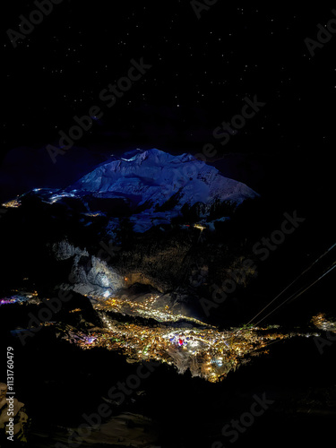 Obraz na płótnie Aerial of illuminated Wengen, Switzerland at night in Winter with blue shining Bietenhorn mountain across w salonie