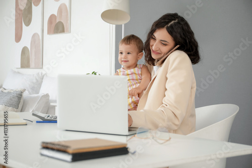 Working mother talking by m...