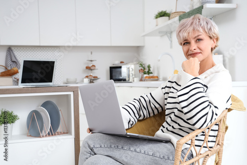 Smiling mature woman using ...