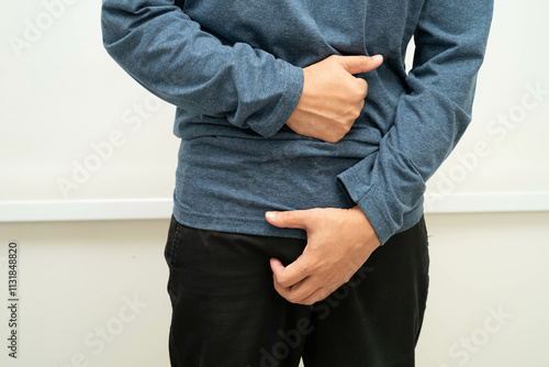 Hernia, Asian man stomach ache, abdominal pain and urology problem health. photo