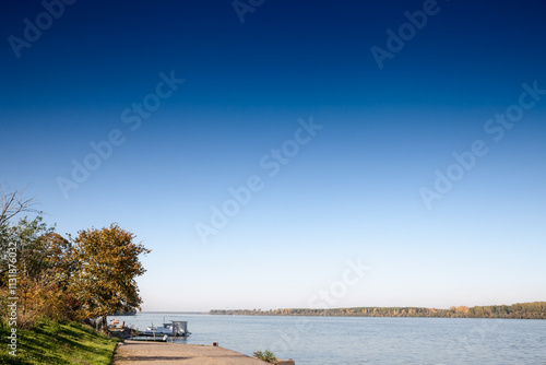 A wide view of the Danube (Dunav) glimmers under a clear autumn sky near Grocka. grocka is a settlement of Belgrade, serbia, on the banks of the danube river. photo