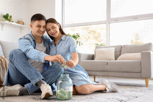 Happy young couple saving m...