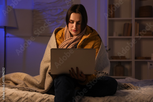 Young woman using laptop in...