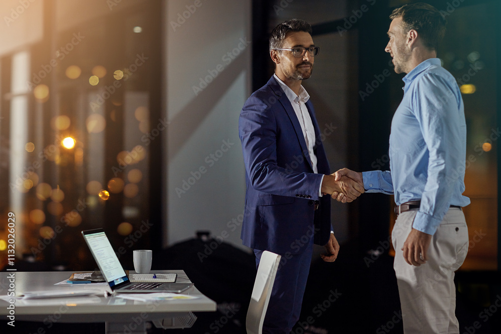 © peopleimages.com - B2B, handshake and partnership with business men in office at night for thank you or welcome. Bokeh, deal and mockup with employee people shaking hands for team onboarding or recruitment on space © peopleimages.com - B2B, handshake and partnership with business men in office at night for thank you or welcome. Bokeh, deal and mockup with employee people shaking hands for team onboarding or recruitment on space