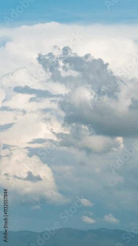 Beautiful summer day sky with fluffy white clouds time lapse in bright blue atmosphere.