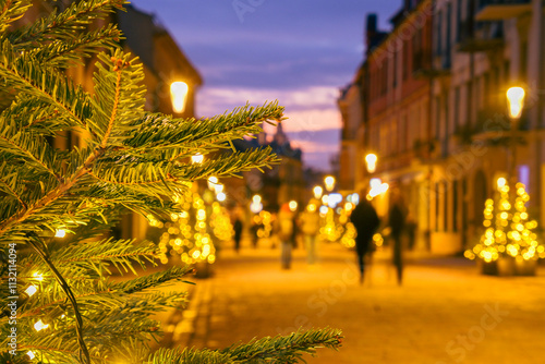 Intentional blur pedestrians walk in famous central street alley of Kaunas. Love Lithuania. Beautiful old traditional line of houses. Christmas holidays photo