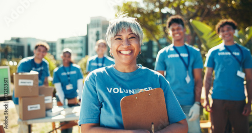 Activism, portrait and smile of woman volunteer outdoor in park for community food drive or donation. Charity, help and society with happy mature person as welfare worker for NGO or non profit photo