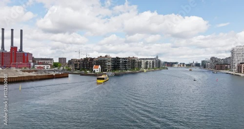 Aerial view around a harbour bus on the Sydhavn river, in Copenhagen, Denmark photo