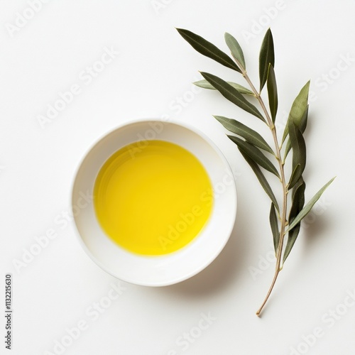 A small bowl of golden olive oil with a few drops of balsamic vinegar swirling on the surface. photo