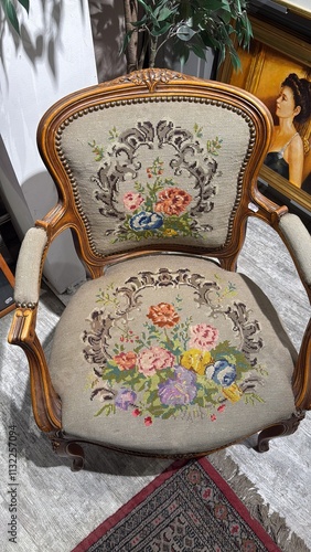 an ornate needlepoint chair with flowers on it 