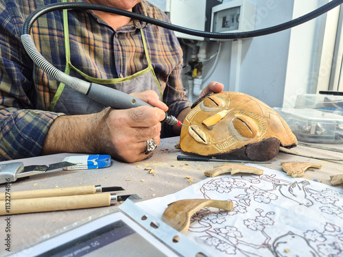 Artist makes mask with water gourd photo