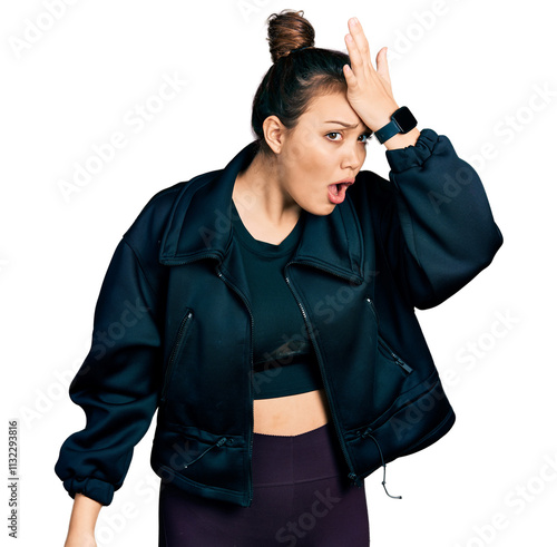 Young hispanic girl wearing sportswear surprised with hand on head for mistake, remember error. forgot, bad memory concept. photo