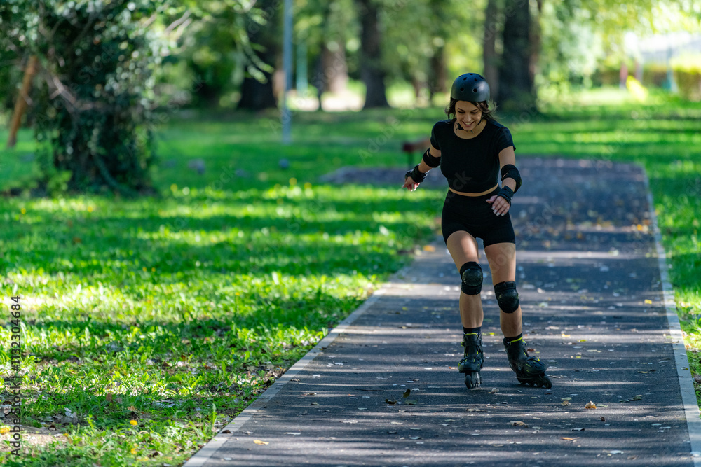 Fototapeta premium Woman rollerblading gracefully in a park, enjoying the fresh air and exercise. The setting showcases vibrant greenery, promoting an active and healthy outdoor lifestyle