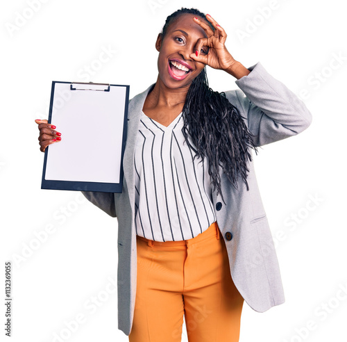 Young african american woman wearing business clothes holding clipboard smiling happy doing ok sign with hand on eye looking through fingers photo