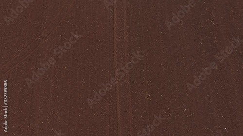 Top down aerial ploughed field track follow