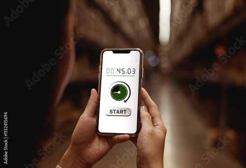 Close-up view of woman using smartphone with start button for timer, countdown timer application photo