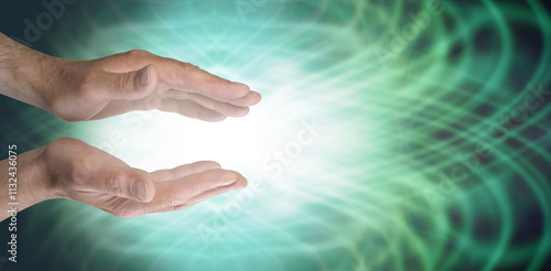 Healing hands and green heart chakra energy field - male parallel hands with white light and radiating green resonating energy field with copy space for text ideal for a Reiki Share invitation  photo