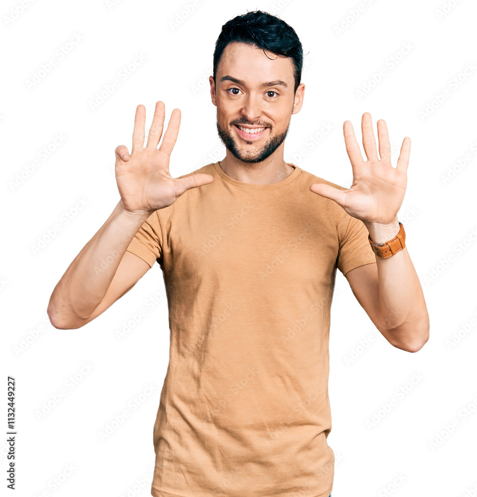 Fototapeta premium Hispanic man with beard wearing casual t shirt showing and pointing up with fingers number nine while smiling confident and happy.
