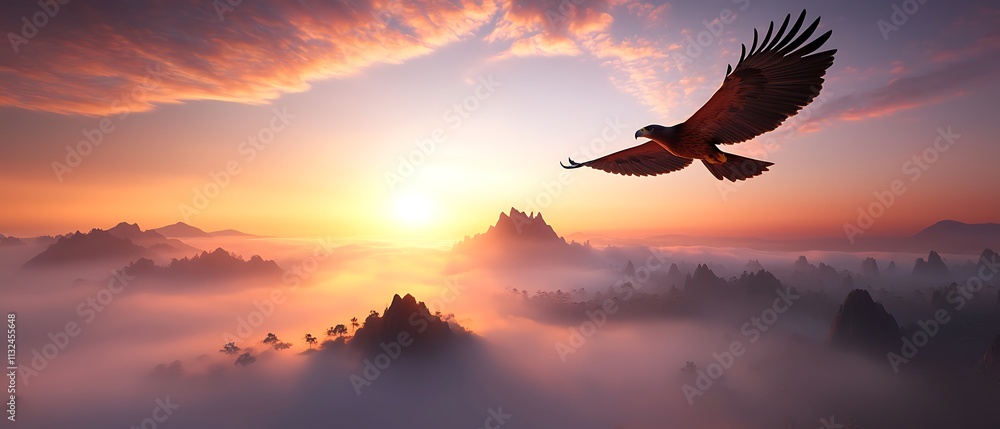 Fototapeta premium Eagle soaring over misty mountains at sunrise.