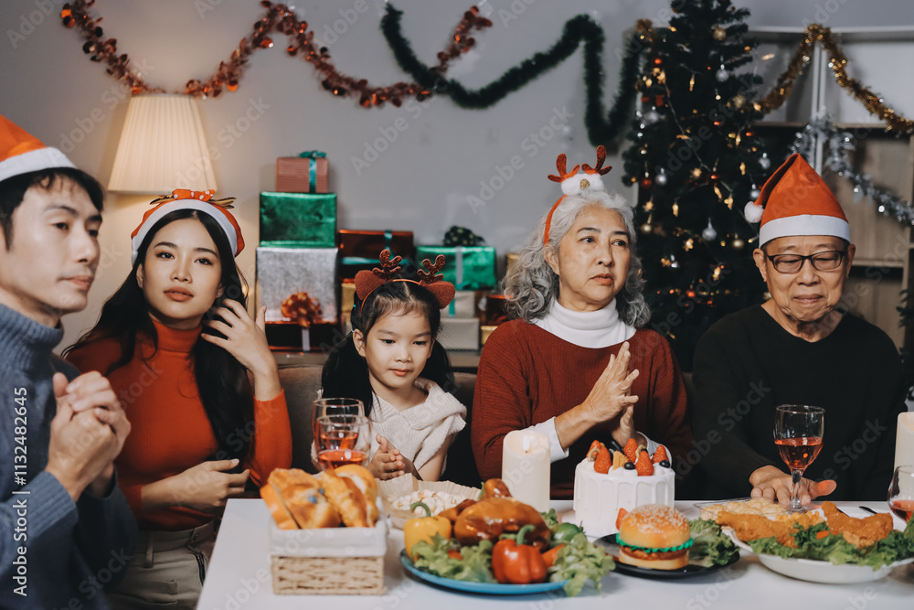 Happy multigeneration family enjoying in opening gifts on Christmas eve at home.