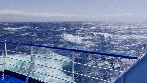 Sailing on a wild sea eith wawes photo