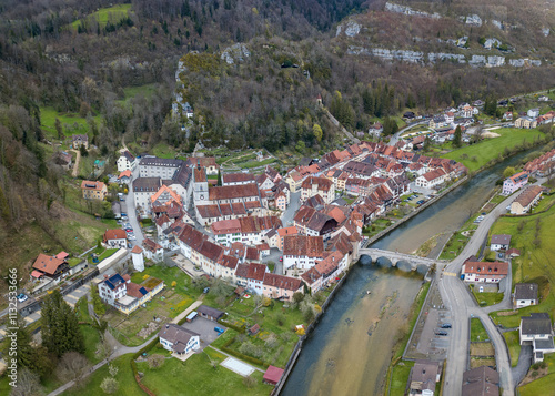 Aerial view of the small medieval town St-Ursanne on River Doubs under Jura Mountains. Saint-Ursanne was once rewarded as one of the most beautiful towns in Switzerland. photo