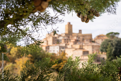 Postcard view of Petroio hilltop village through cypress tree branches in Tuscany, Italy photo