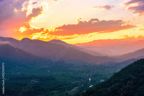 sceniv view an amazing twinlight mountain among beautiful evening sunset clouds, nature landscape photo