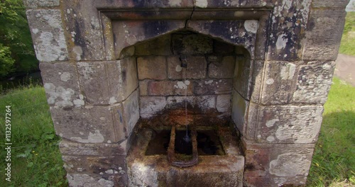 mid shot of stone fountain of St mungos well at holystone Northumbria. photo