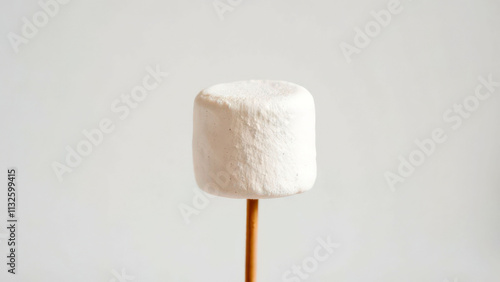 Single marshmallow on stick against minimalist background photo