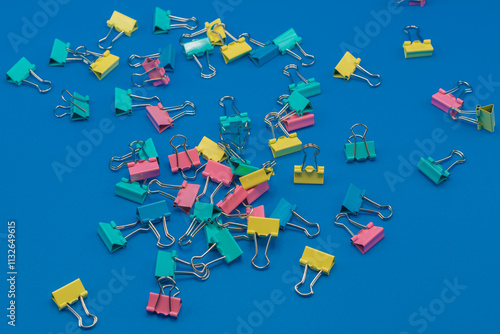Clothespins scattered on a blue background.