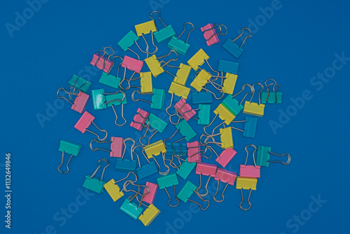 Clothespins scattered on a blue background.