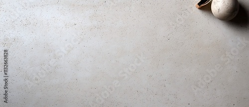 Grey textured surface with small, round objects.