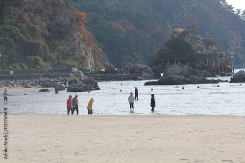 Image of people walking barefoot at Dadaepo Beach in Busan
 photo