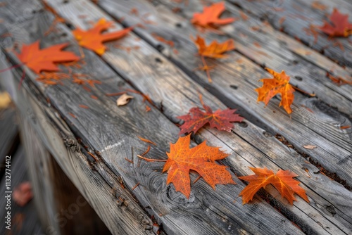 Autumn leaves scattered on weathered wooden planks photo