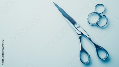 Top-down view of scissors with sharp blades and modern design, resting flat on a bright white surface  photo