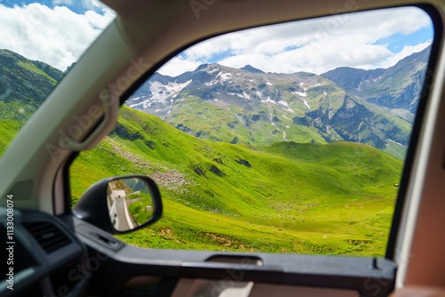 Принти на полотні A lush green mountain landscape with snow-capped peaks and a blue sky can be seen from a car window while driving on a road in Kaprun, Zell am See, Pinzgau, Land Salzburg, Austria