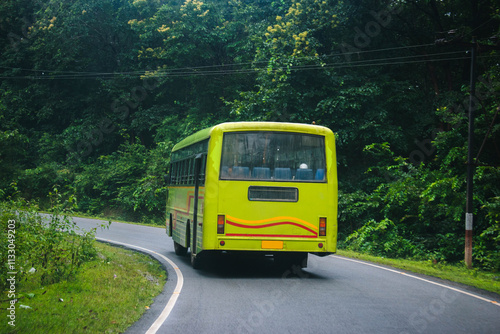 Green ksrtc bus on the road in the forest. Travel concept.