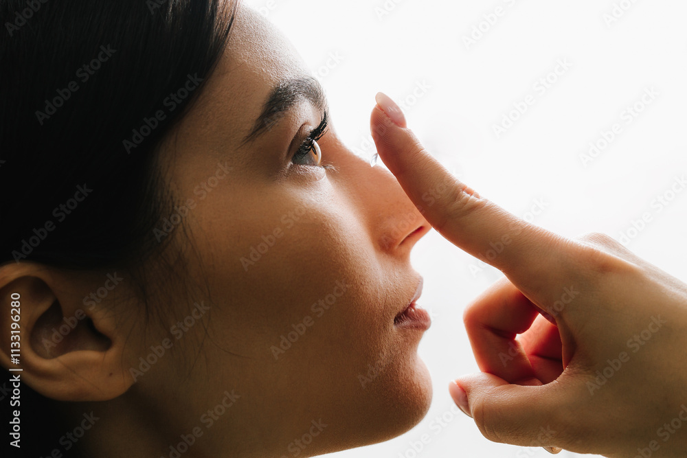 Obraz premium Preparing contact lens before use for myopia treatment by woman. Myopia and astigmatism therapy with eye lenses chosen by ophthalmologist.