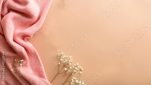 Hello spring concept. Top view photo of pink soft scarf and gypsophila flowers on isolated pastel beige background with copyspace photo