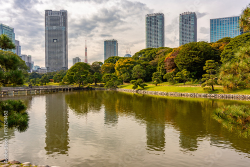 Hamarikyu gardens with skyscrapers at background in autumn, Tokyo, Japan