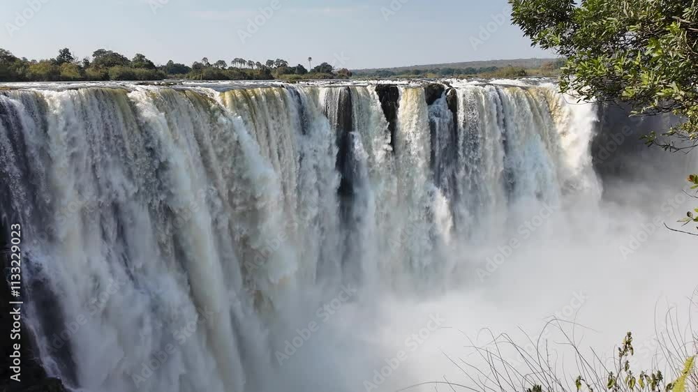 Victoria Falls At Livingstone Northern Rhodesia Zambia. Rainbow Forming Over Waterfalls With River In Background. Leisure Forest Water Fall Beautiful. Leisure Travel Landscape. Victoria Falls At Livingstone Northern Rhodesia Zambia. Rainbow Forming Over Waterfalls With River In Background. Leisure Forest Water Fall Beautiful. Leisure Travel Landscape.