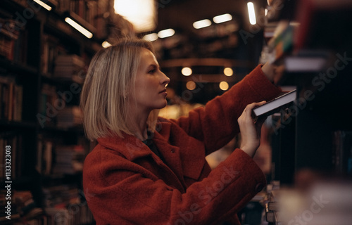 In a Cozy Bookstore During the Peaceful Hours of the Evening, a Young Woman Dressed in a Vibrant Red Coat Leisurely Browses Through the Diverse Collection of Books Shelved All Around Her
