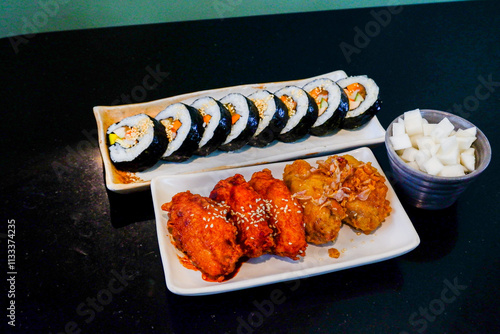 Korean foods served on a dining table,Gimbap,Fried chicken, radish,kimchi on table in korean restaurant,street food,copy space.. photo