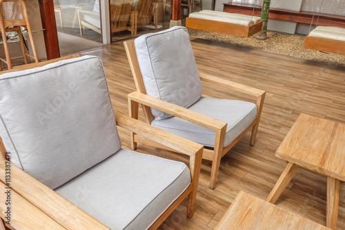 Wooden chair and wooden table in restaurant,Rattan chair in scandinavian interior of living room,Mediterranean minimal wall and green plant exterior architecturer,warm beige tones,copy space. photo