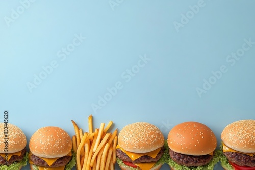 Delicious burgers arranged with crispy fries on a vibrant blue background